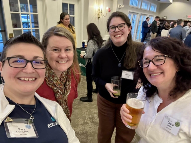 Sara, Stacy, Hannah, and Diana smiling during the social hour at the AMWS annual meeting.