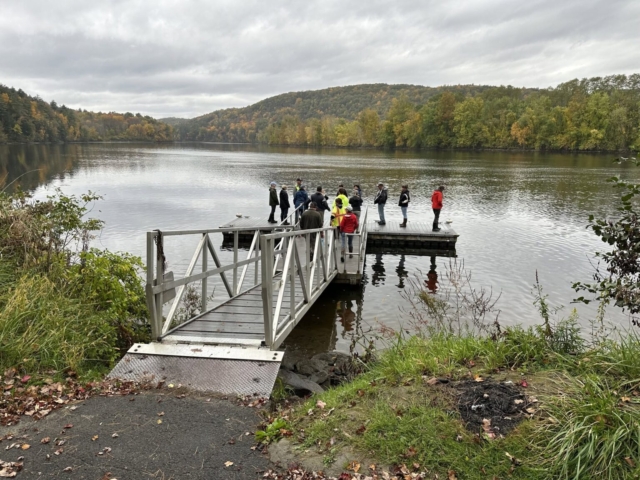 Attendees delineating the mean annual high water line from a floating river dock.